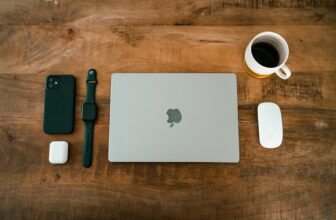 Wireless earbuds on a desk with coffee