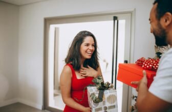 Joyful couple exchanging gifts indoors, capturing the essence of holiday happiness.