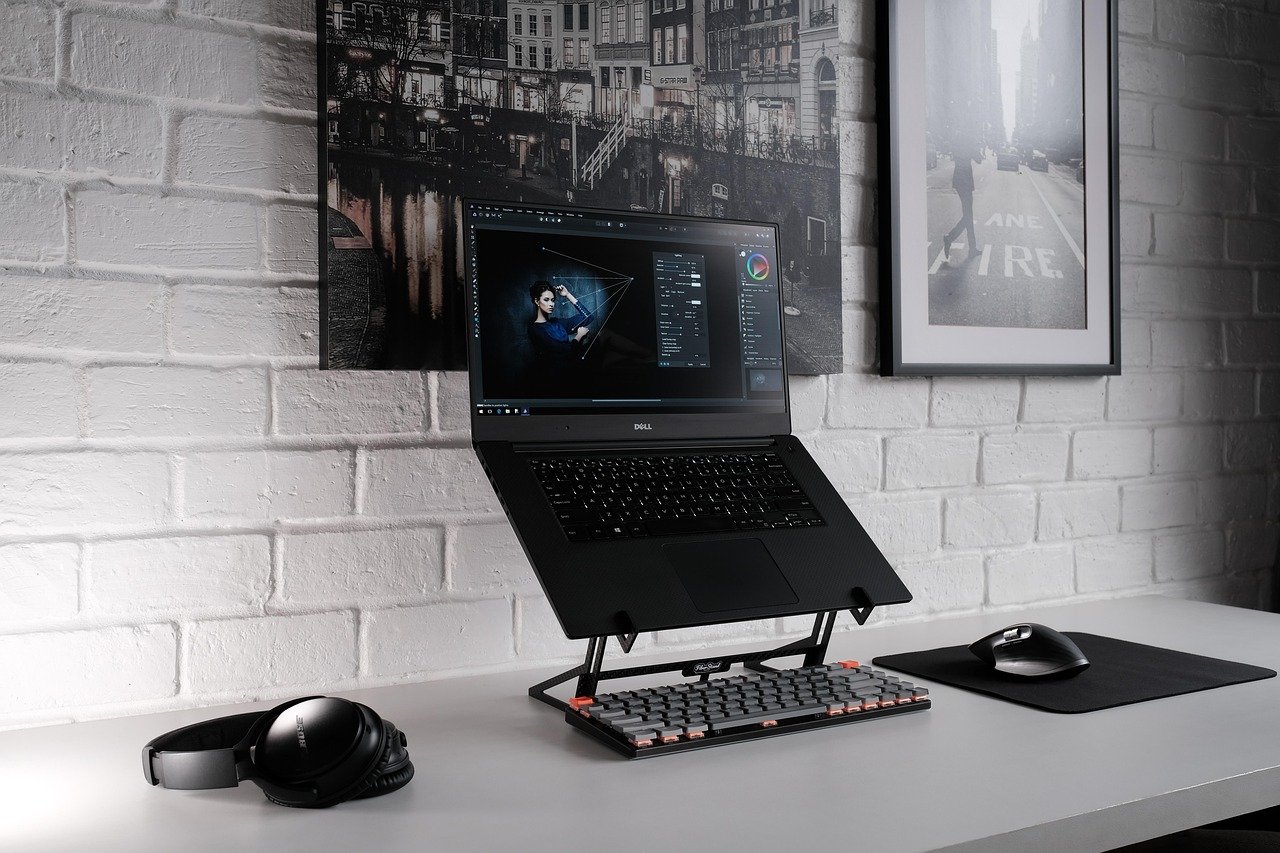 laptop, desk, office, workspace, office space, digital nomad, laptop stand, laptop riser, mechanical keyboard, headphones, computer mouse, mouse pad, work, desk setup, remote work, work from home, graphic designer, photo editing, photoshop, digital nomad, laptop stand, laptop stand, laptop stand, laptop stand, laptop stand, desk setup, desk setup, remote work, remote work, remote work, remote work, photo editing, photo editing