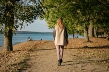 Woman walking on a sunlit park path