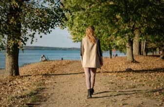 Woman walking on a sunlit park path