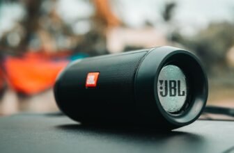Focused shot of a black JBL portable speaker on a surface, ideal for technology concepts.