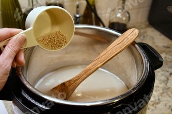 Pouring steel-cut oats into an Instant Pot for creamy tasty porridge.