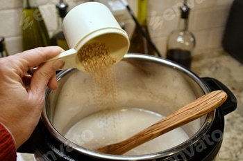 Pouring steel-cut oats into an Instant Pot for creamy tasty porridge.